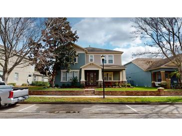 Charming two-story home with a covered front porch and well-manicured landscaping at 5406 Fishhawk Ridge Dr, Lithia, FL 33547