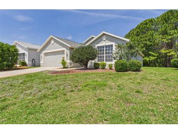 Charming single-story home with well-manicured lawn and lush landscaping at 10169 Holly Berry Dr, Weeki Wachee, FL 34613