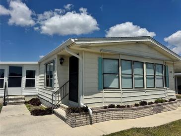 Charming single-story home featuring blue shutters and neat landscaping in a well-maintained community at 341 Outrigger Pl, North Port, FL 34287