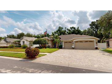 Beautiful single-story home featuring a paver driveway and a well-manicured lawn at 4506 Gentrice Dr, Valrico, FL 33596