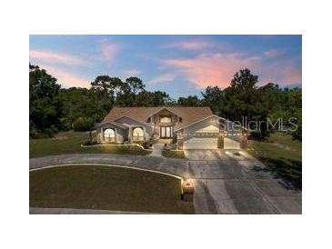 Two-story house with large driveway and landscaping at 13473 Bruni Dr, Spring Hill, FL 34609