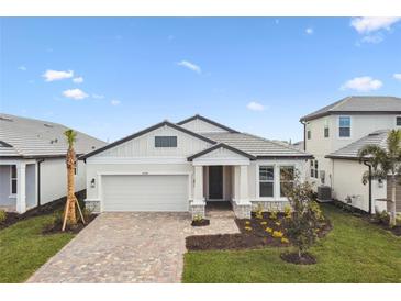 Charming single-story home featuring a brick-paved driveway, two car garage, and manicured front yard at 17340 Savory Mist Cir, Bradenton, FL 34211