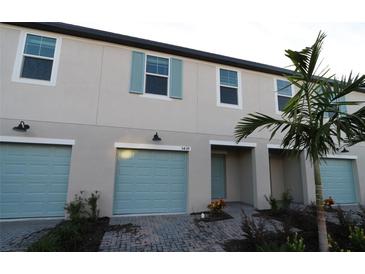 Modern townhouse with light blue garage doors at 5439 Tripoli Dr, Palmetto, FL 34221