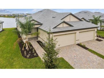 Two-car garage, double-wide driveway, and attractive landscaping at 18019 Cherished Loop, Bradenton, FL 34211