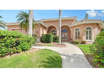 Inviting front yard with lush landscaping and a paved walkway leading to the entrance at 8809 Havenridge Dr, Sarasota, FL 34238