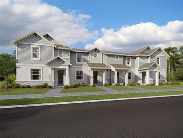 Three-unit townhome building with gray siding, stone accents, and covered porches at 7472 Cabin Ln, Sarasota, FL 34240