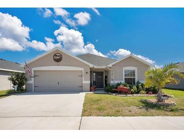 Charming single-story home boasts a two-car garage, well-kept lawn, and tropical landscaping in a desirable neighborhood at 11820 Stone Pine St, Riverview, FL 33569