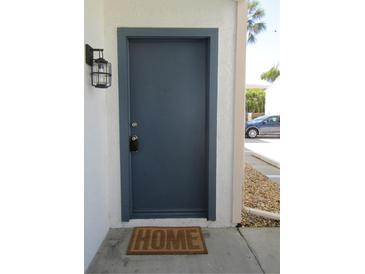 Inviting entryway features a painted front door, stylish lantern, and a 