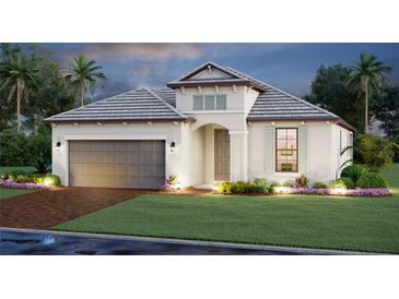 Beautifully landscaped single-story home featuring a two-car garage and neutral color palette at 17216 Savory Mist Cir, Bradenton, FL 34211