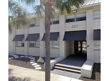 Exterior view of a modern office building with awnings at 227 Central Ave, Sarasota, FL 34236
