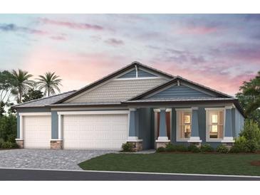 Charming single-Gathering home with a three-car garage and well-manicured lawn under a pink and purple sunset at 1688 Lugano Cir, Nokomis, FL 34275