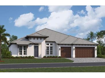 A charming single-story home featuring a light exterior, two-car garage, and meticulously manicured landscaping at 18534 Foxtail Loop, Venice, FL 34293