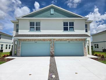 New two-story townhome with two-car garage and manicured landscaping at 13964 Emerald Fields Dr, Hudson, FL 34667