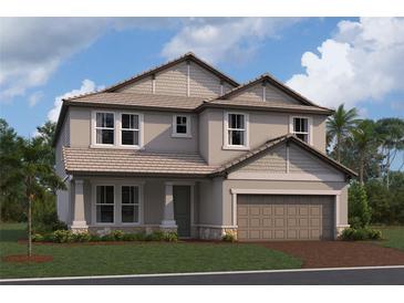 Charming two-story home with a two-car garage and beautifully manicured lawn at 17106 Savory Mist Cir, Lakewood Ranch, FL 34211