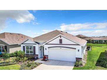 Charming single-Gathering home with a well-manicured lawn and a two-car garage at 17518 Canopy Pl, Bradenton, FL 34211