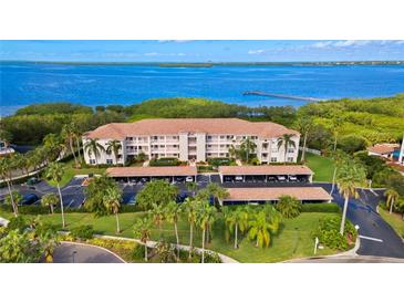 Waterfront condo building with covered parking and lush landscaping at 2725 Terra Ceia Bay Blvd # 201, Palmetto, FL 34221