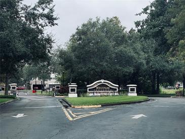 Westpark community entrance featuring sign, mature trees, and wrought iron gate at 10453 Westpark Preserve Blvd, Tampa, FL 33625