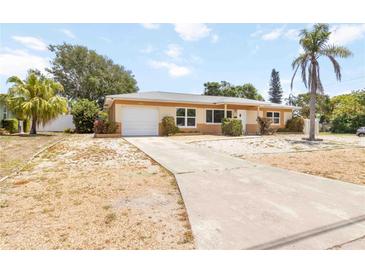 Charming single-story home featuring a front lawn, an attached garage and a concrete driveway at 1801 40Th N St, St Petersburg, FL 33713
