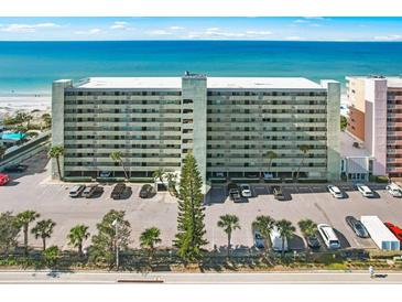 Aerial view of beachfront building with parking lot at 20000 Gulf Blvd # 707, Indian Shores, FL 33785