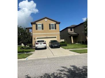 Two-story house with a two-car garage and well-maintained lawn at 6327 Yellow Buckeye Dr # 6327, Riverview, FL 33578