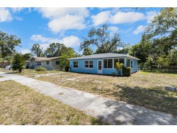 Quaint one-story blue house with a well-lit sunroom and sidewalk to street at 1724 Harbor Dr, Clearwater, FL 33755