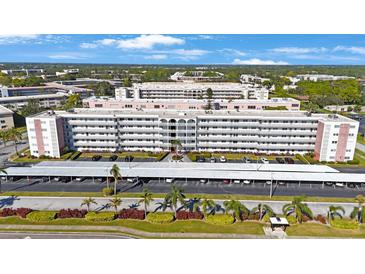 Spacious condominium featuring lush landscaping, assigned covered parking and desirable curb appeal at 5501 80Th N St # 201, St Petersburg, FL 33709