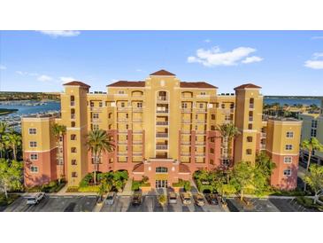 Beautiful condo building with manicured landscaping and convenient parking at 606 Riviera Dunes Way # 207, Palmetto, FL 34221