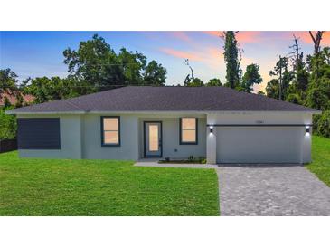 Charming single-story home with well-manicured lawn and a paved driveway leading to a two-car garage at 23113 Brewer Ave, Punta Gorda, FL 33980