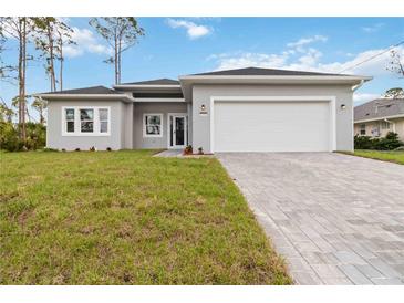 Charming single-story home with a two-car garage, landscaped yard and brick paver driveway at 4160 Belladonna Ave, North Port, FL 34286