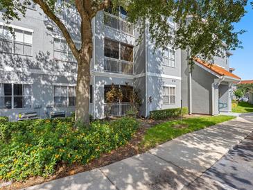 Charming condo exterior featuring multiple balconies, beautiful landscaping, and a well-maintained facade in a serene setting at 18001 Richmond Place Dr # 126, Tampa, FL 33647