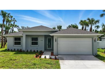 Charming single-story home with a well-manicured lawn and a two car attached garage at 4098 New Milford St, North Port, FL 34288