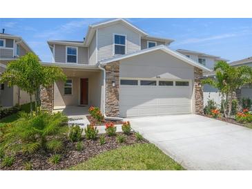 Beautiful two-story home featuring a two-car garage and professionally landscaped front yard at 6046 Jensen View Ave, Apollo Beach, FL 33572
