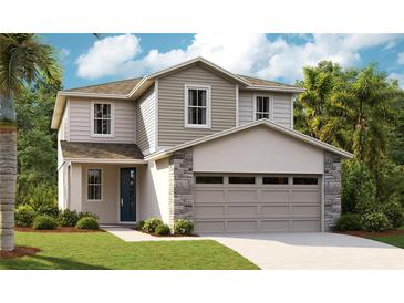 Charming two-story home with stone accents, a two-car garage, and a beautifully landscaped lawn at 6046 Jensen View Ave, Apollo Beach, FL 33572