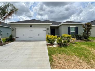 Charming single-story home featuring a two-car garage, well-maintained lawn, and fresh landscaping at 17130 11Th Ter E, Bradenton, FL 34212