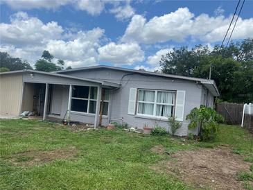 Exterior of home with blue sky and landscaped yard, offering a peaceful view at 1009 Kenmore Dr, Brandon, FL 33510
