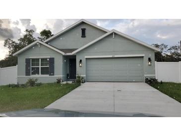 Charming single-story home with a two-car garage, neat landscaping, and a well-maintained front lawn at 6315 Hillview Rd, Spring Hill, FL 34606
