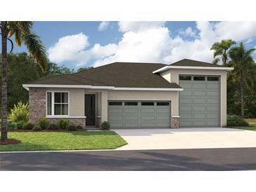 Charming single-story home with a three-car garage and stone accents on the facade at 9005 Players Dr, Weeki Wachee, FL 34613
