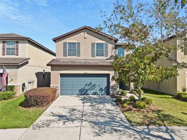 Charming two-story home featuring a two-car garage, well-maintained landscaping, and inviting curb appeal at 4502 Banyan Tree Pl, Riverview, FL 33578