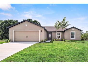 Newly constructed home with a two-car garage and well-manicured lawn at 5389 Ulysses St, Port Charlotte, FL 33981