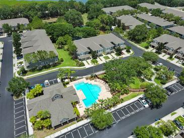 Aerial view of a community featuring townhomes, pool, landscaping, and parking at 2220 Kings Palace Dr, Riverview, FL 33578