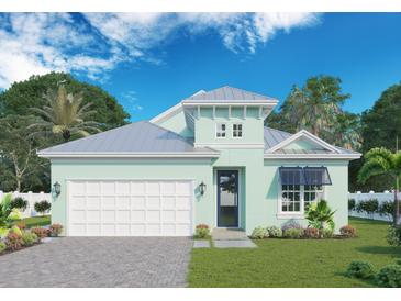 Coastal-style home with light-green exterior and metal roof at 421 Bahama Grande Blvd, Apollo Beach, FL 33572