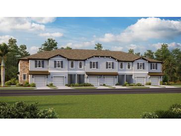 New townhouses with attached garages and lush landscaping at 10413 Lavender Aster Trl, San Antonio, FL 33576