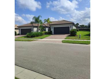 Two-story house with a two car garage and landscaped yard at 12831 Oriago St, Venice, FL 34293