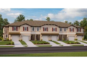 New townhome community with attached garages and landscaping at 10368 Honey Hammock Way, San Antonio, FL 33576