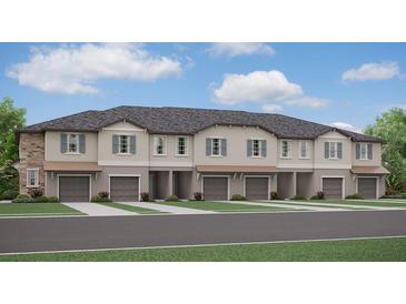 Modern townhome community with attached garages and neutral colors at 10384 Honey Hammock Way, San Antonio, FL 33576