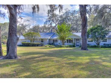 Ranch-style home with a large yard and mature trees at 12945 Morris Bridge Rd, Thonotosassa, FL 33592