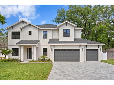 Beautiful two story home with three car garage, lovely landscaping, and modern design at 4005 W San Rafael St, Tampa, FL 33629