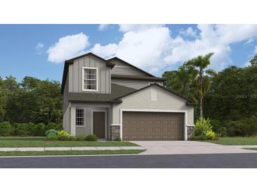 Two-story home with brown garage door and gray siding at 2530 Leonia Ln, Zephyrhills, FL 33541