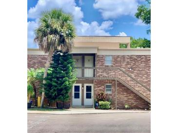 Brick building with two entrances and a stairway at 10423 Carrollbrook Cir # 201, Tampa, FL 33618