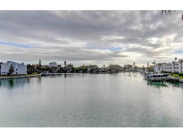Scenic waterfront view showcasing the tranquil canal lined with homes and docked boats under a cloudy sky at 12246 2Nd E St # 503, Treasure Island, FL 33706